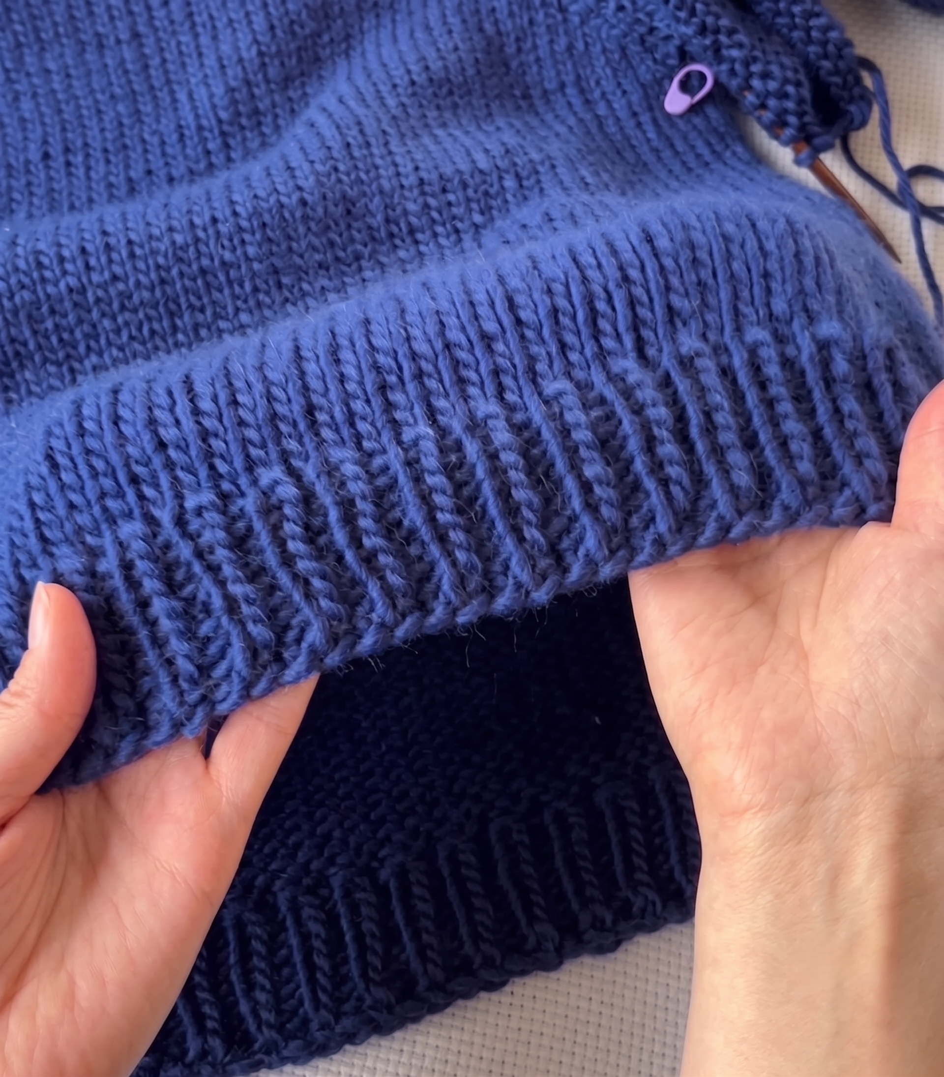A hand checking a hem